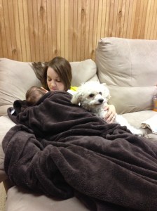 Sick momma with her babies keeping her company on the couch