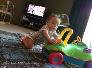 Lucas started pulling himself up.  He's done it on my diaper bag, the couch, and now he's starting to learn how to on his toy.  He's going to skip walking and just go straight into running I think...