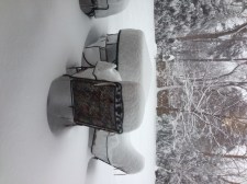 By 2pm, the snow is already to the seat on the chair and above my knee past the patio set